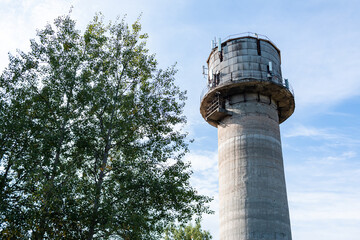 Old water tower with cell phone antennas.
