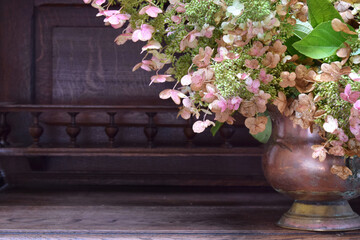 Autumn composition of flowers in vintage copper pot