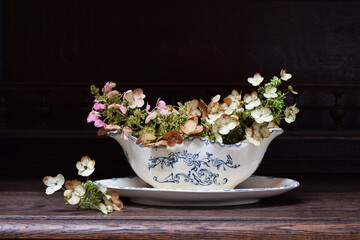 Autumn composition of flowers in vintage sauceboat