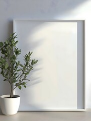 A minimalist composition featuring a blank white frame beside a potted green plant, creating a serene and modern aesthetic in a softly lit space.