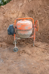 Old concrete mixer at a construction site.