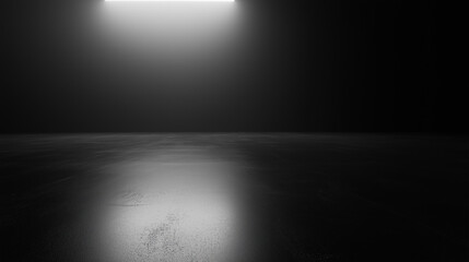 .Dark empty room with a spotlight illuminating the textured floor