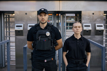 Diverse police officers patrolling and guarding entrance to public subway