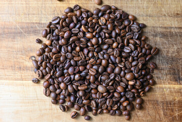 coffee beans scattered on a wooden table