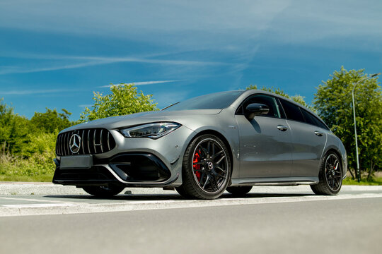 Krakow, Poland - June 14, 2024: Color: graphite, Mercedes-Benz CLA AMG 45 S 4-Matic 8G-DCT, 241 HP, braking photos, year: 2020. Car parked under the sky on a sunny day, on the street. Sports version