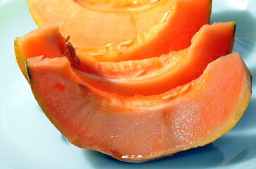 Slices of juicy cantaloupe melon on a plate.