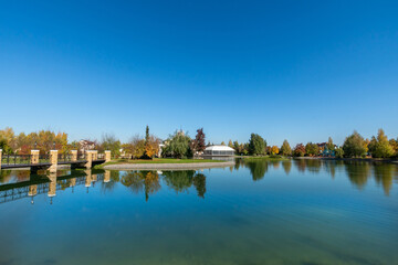 The calm surface of the river against the blue sky. Natural landscape on a sunny day.