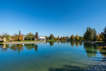 Obraz premium Beautiful landscape on a clear sunny day. The calm surface of the river, green trees along .the shore.
