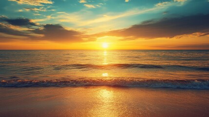 Fototapeta premium Sunset at the beach with waves gently rolling ashore
