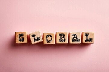 Obraz premium Words GLOBAL writing on small wooden blocks on isolated background. Business and economy concept 