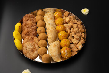 Indian sweets in a plate includes anarsa, shakkarpara morichoor  Bundi Laddu, Gujiya or Karanji for diwali celebration