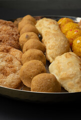 Indian sweets in a plate includes anarsa, shakkarpara morichoor  Bundi Laddu, Gujiya or Karanji for diwali celebration