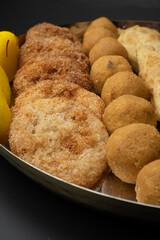 Indian sweets in a plate includes anarsa, shakkarpara morichoor  Bundi Laddu, Gujiya or Karanji for diwali celebration