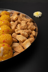 Indian sweets in a plate includes anarsa, shakkarpara morichoor  Bundi Laddu, Gujiya or Karanji for diwali celebration