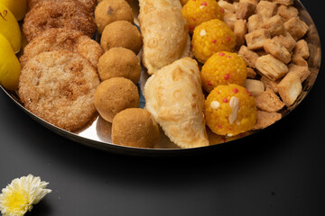 Indian sweets in a plate includes anarsa, shakkarpara morichoor  Bundi Laddu, Gujiya or Karanji for diwali celebration