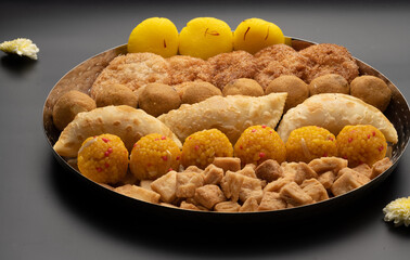 Indian sweets in a plate includes anarsa, shakkarpara morichoor  Bundi Laddu, Gujiya or Karanji for diwali celebration