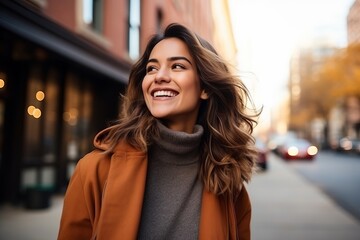 Portrait of a beautiful young woman walking on the street in autumn