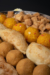 Indian sweets in a plate includes anarsa, shakkarpara morichoor  Bundi Laddu, Gujiya or Karanji for diwali celebration