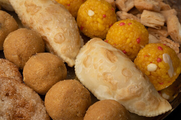 Indian sweets in a plate includes anarsa, shakkarpara morichoor  Bundi Laddu, Gujiya or Karanji for diwali celebration