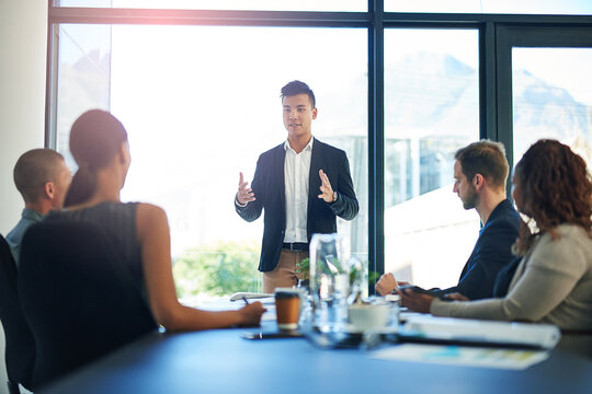 Business, man and proposal at boardroom in meeting for feedback, report and pitch as entrepreneur. People, employee and clients at office with presentation for project funding and partnership