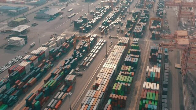 ASAN, SOUTH KOREA - OCTOBER 15, 2024: Busy shipping port with stacked containers and cranes during daytime operations