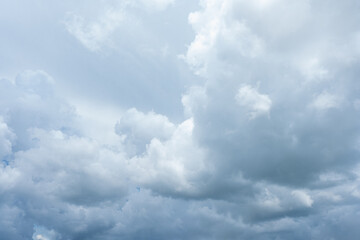 Fluffy white clouds drift across a clear blue sky, painting a beautiful summer day