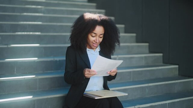 Worried young businesswoman checking mail open envelope and celebrate win success reading great news feel amazed happy reading work result enrolment letter at business centre Triumph Wow concept