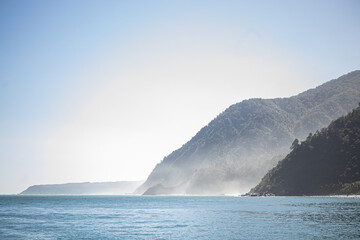 milford sound fjord with mountains and sun

