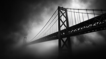 Fototapeta premium Veil of Fog: A Monochromatic Perspective on the Majestic Bridge Connecting Shores Amidst Mysterious Mist and Shadows