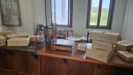 Historical office desk with old books and writing tools in a museum