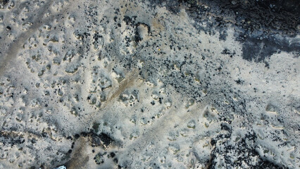 Aerial view of lava flow solidifying on rocks creating abstract shapes