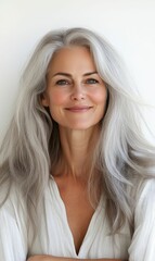 Naklejka premium Woman with gray hair and white shirt smiling.