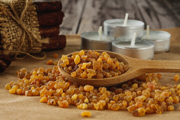 Natural Aromatic Frankincense and Myrrh Resin with Wooden Spoon on Rustic Table