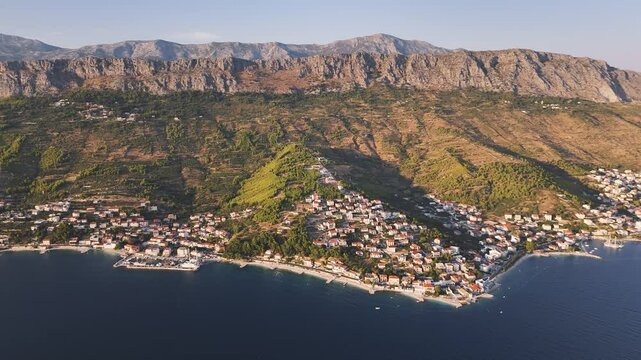 Panoramic drone view of the Croatian coastline with mountain ranges in the background. Split-Dalmatia County, Croatia