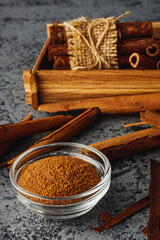 Closeup of Aromatic Ground Cinnamon and Sticks on a White Background