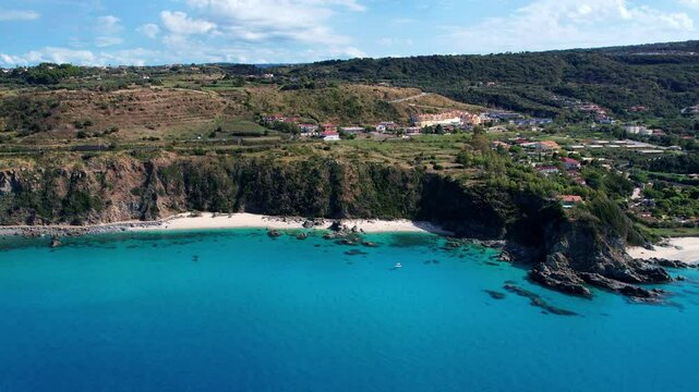 4K Aerial drone video of one of the most beautiful beaches in the world with turquoise clear blue water and white sand with big rocks on a sunny summer day. Marinella di Zambrone Paradiso Tropea Italy