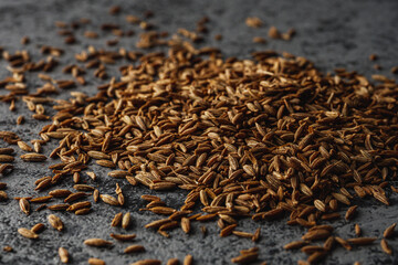 Closeup of Aromatic Cumin Seeds and Spices on a Rustic Background