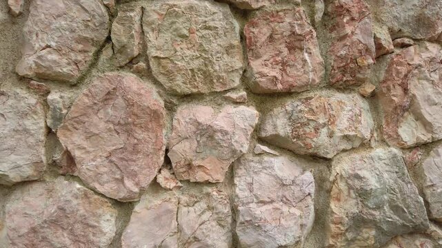 Smooth camera movement capturing the details of a stone wall