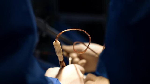 Modern electric tool device in hands of a surgeon. Close up. Blurred backdrop. Neurosurgery progress.