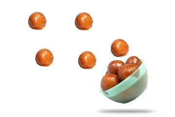 Gulab jamun falling from green bowl. Traditional Indian dessert on white background perfect for ads