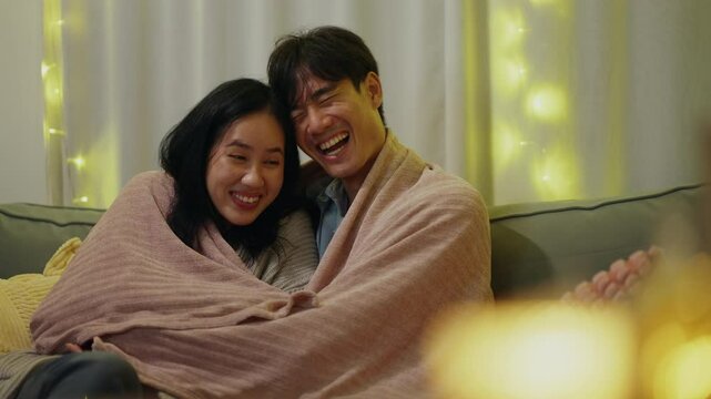 Home, happy Asia couple with hug on sofa for weekend romance, partnership and bonding together. Man, love and woman with affection in living room on couch for connection, support and trust in marriage