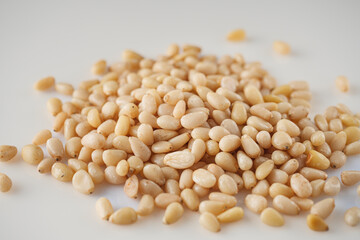 Shelled Pine Nuts: Close-Up of Roasted Siberian Seeds on a White Background