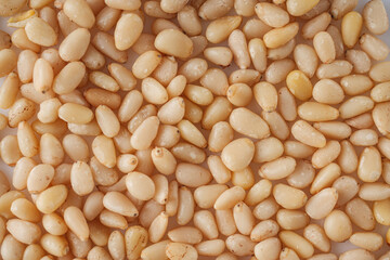 Shelled Pine Nuts: Close-Up of Roasted Siberian Seeds on a White Background
