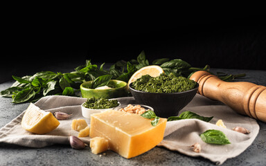 Homemade Pesto Sauce with Pine Nuts and Basil: Ingredients on Black Background