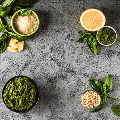 Homemade Pesto Sauce with Pine Nuts and Basil: Ingredients on Black Background