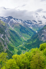 Fototapeta premium Beautiful landscape of valley in Alpine mountains, small trail, hike root, majestic picturesque view in sunny day