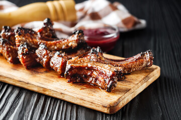 Rustic Grilled BBQ Ribs with Red Sauce Pork and Beef Roasted on Charcoal Wooden Background Delicious Meal