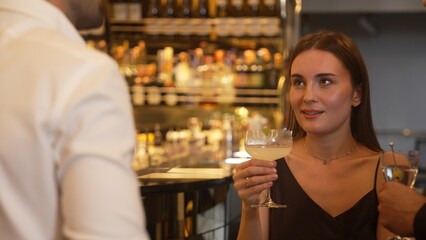 Focusing beautiful woman lively talking with friends while enjoy drinking Margarita cocktail at luxurious counter bar nightclub creating vibrant engaging atmosphere on Friday night meeting. Vinosity.