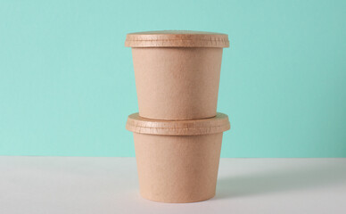 Eco cardboard round food box on table, mint green background