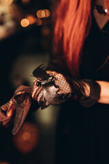 Close-up of Halloween gloves with bat decoration in dramatic lighting